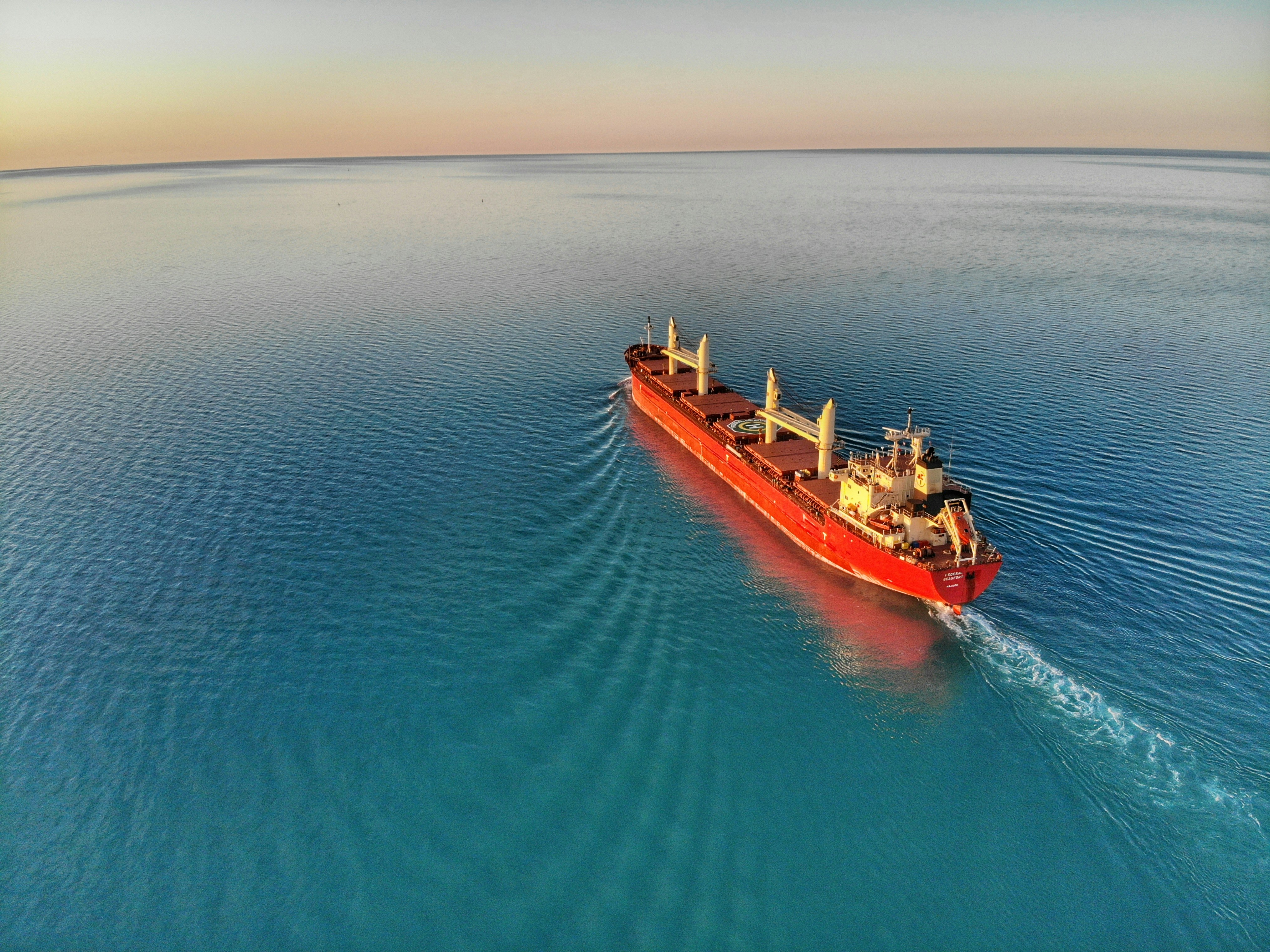 Bulk carrier ship at sunset on the ocean