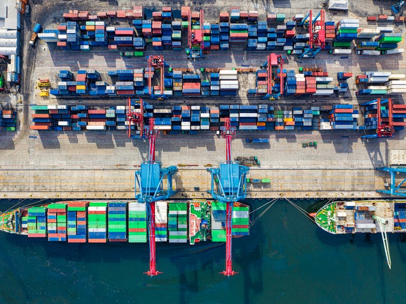 Aerial view of container port with cranes and cargo operations