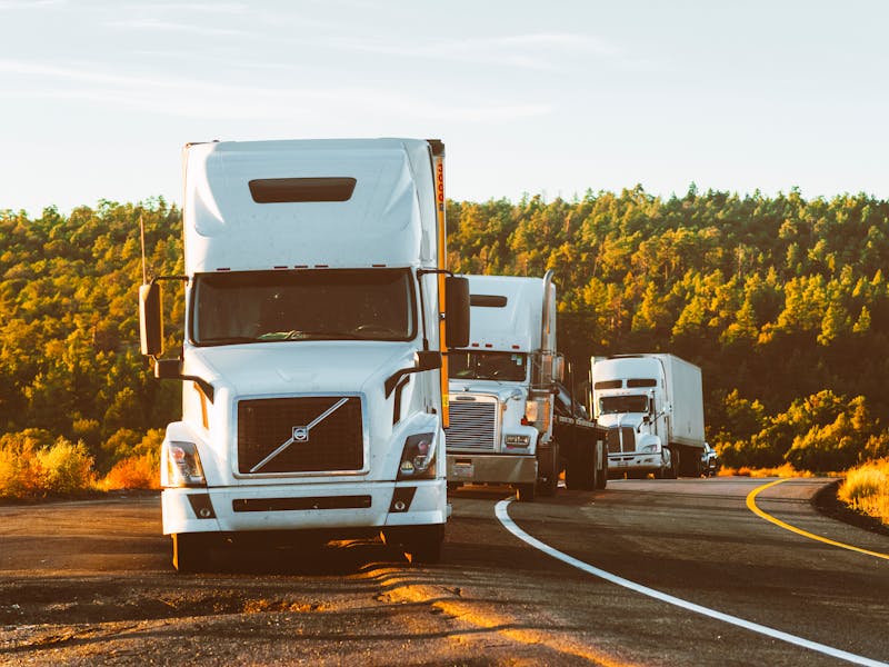 Freight trucks on highway at golden hour